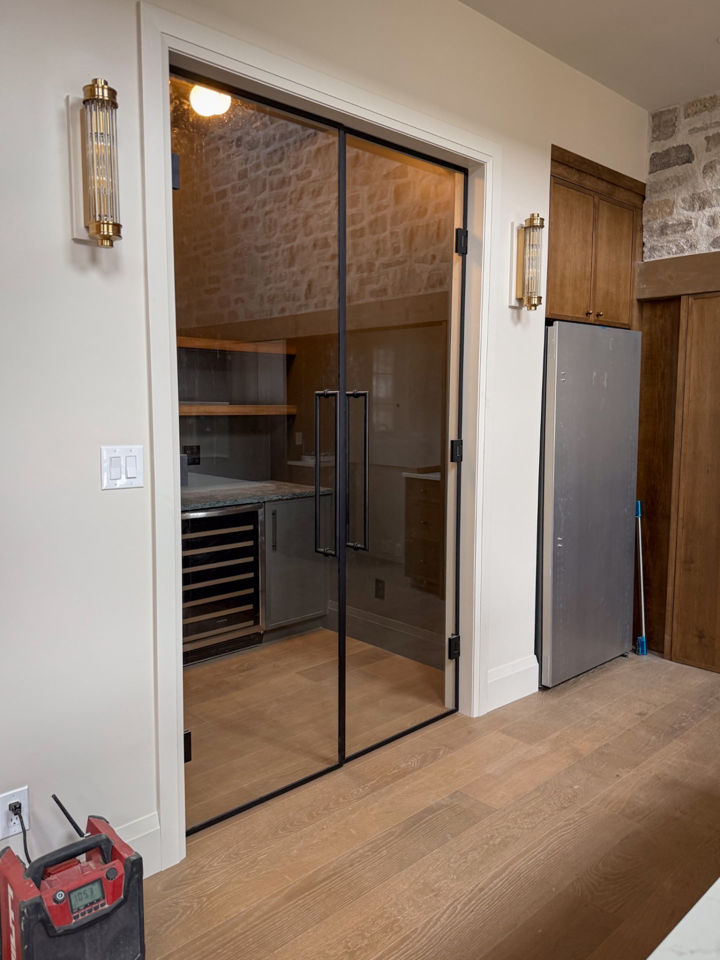 Glass door and stone accent wall — Boronka Carpentry Plus