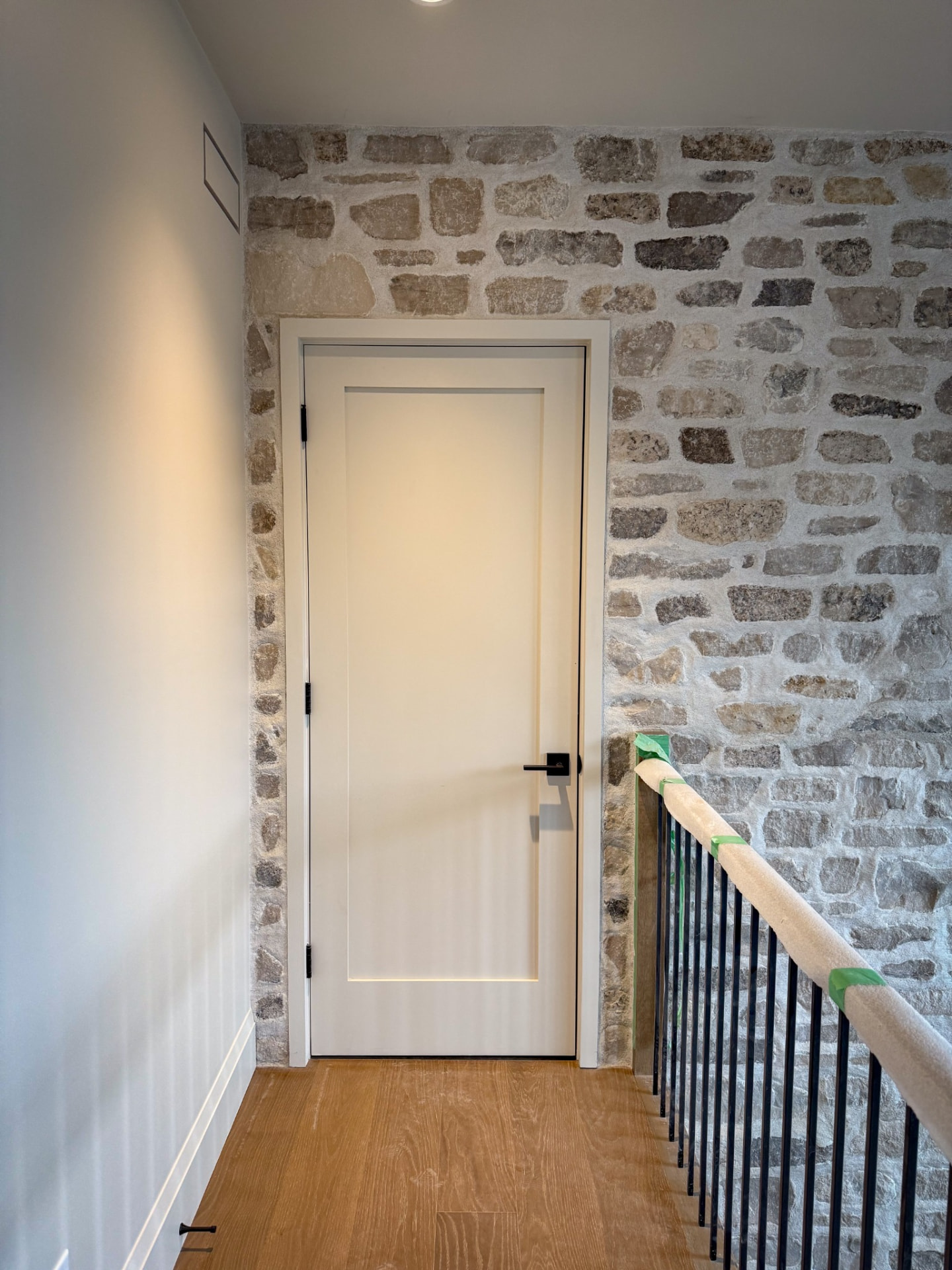 Stone accent wall and interior door — Boronka Carpentry Plus